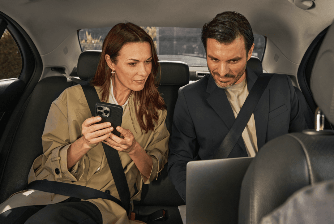 Two business travellers riding in Freenow taxi